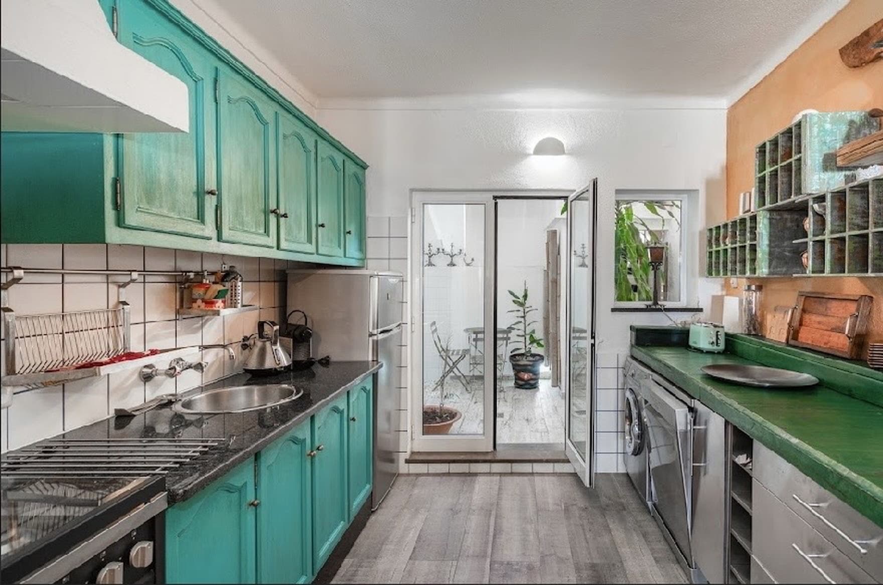 Fully equipped kitchen with turquoise cabinets