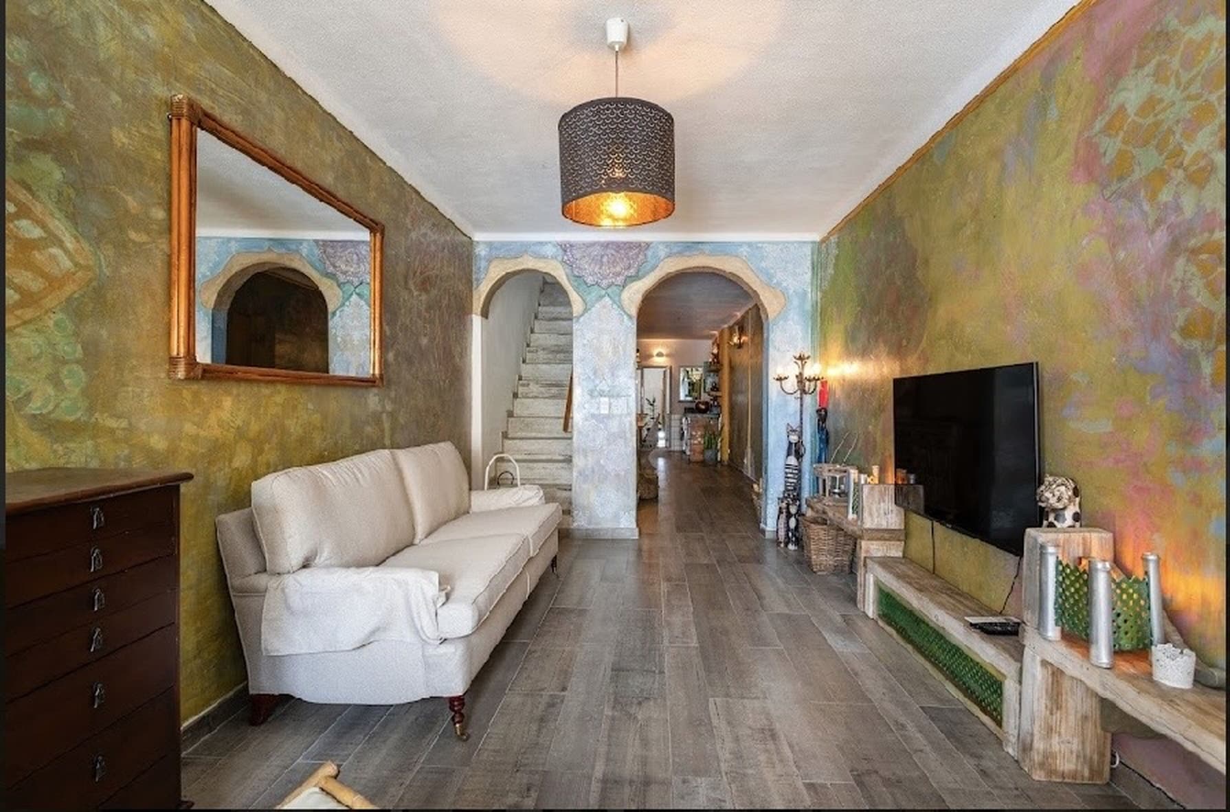 Living room with Moorish archways and hand-painted walls